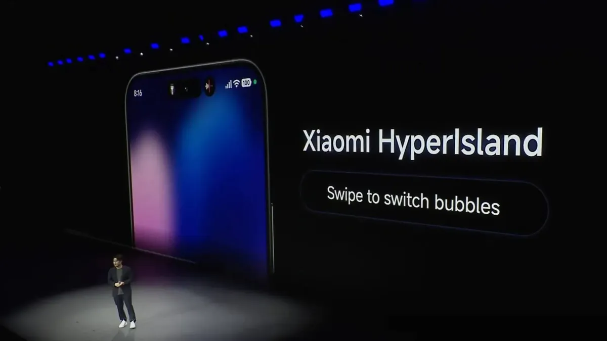 Презентация Xiaomi HyperIsland — смартфон на сцене, надпись «Swipe to switch bubbles»